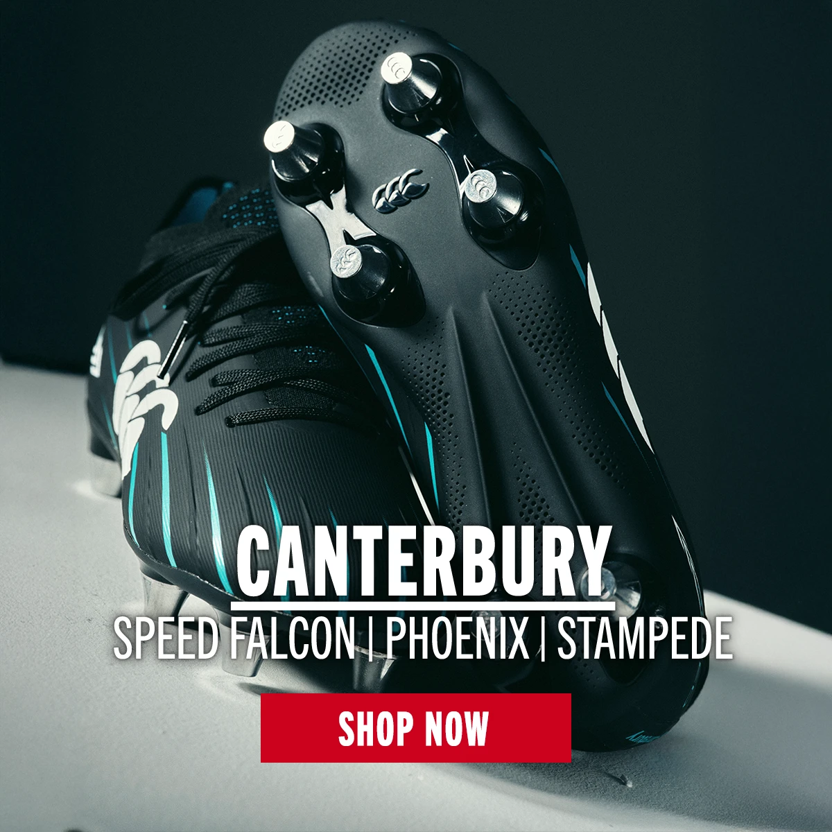 A pair of Canterbury Speed Falcons sit on a dutch angle to show off both the top and bottom of the rugby boot.