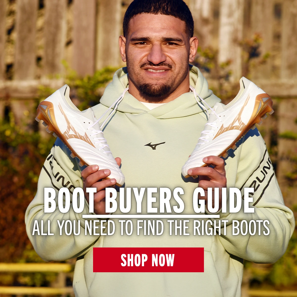 Boot Buyers Guide Sione Tuipulotu stands holding Mizuno boots.