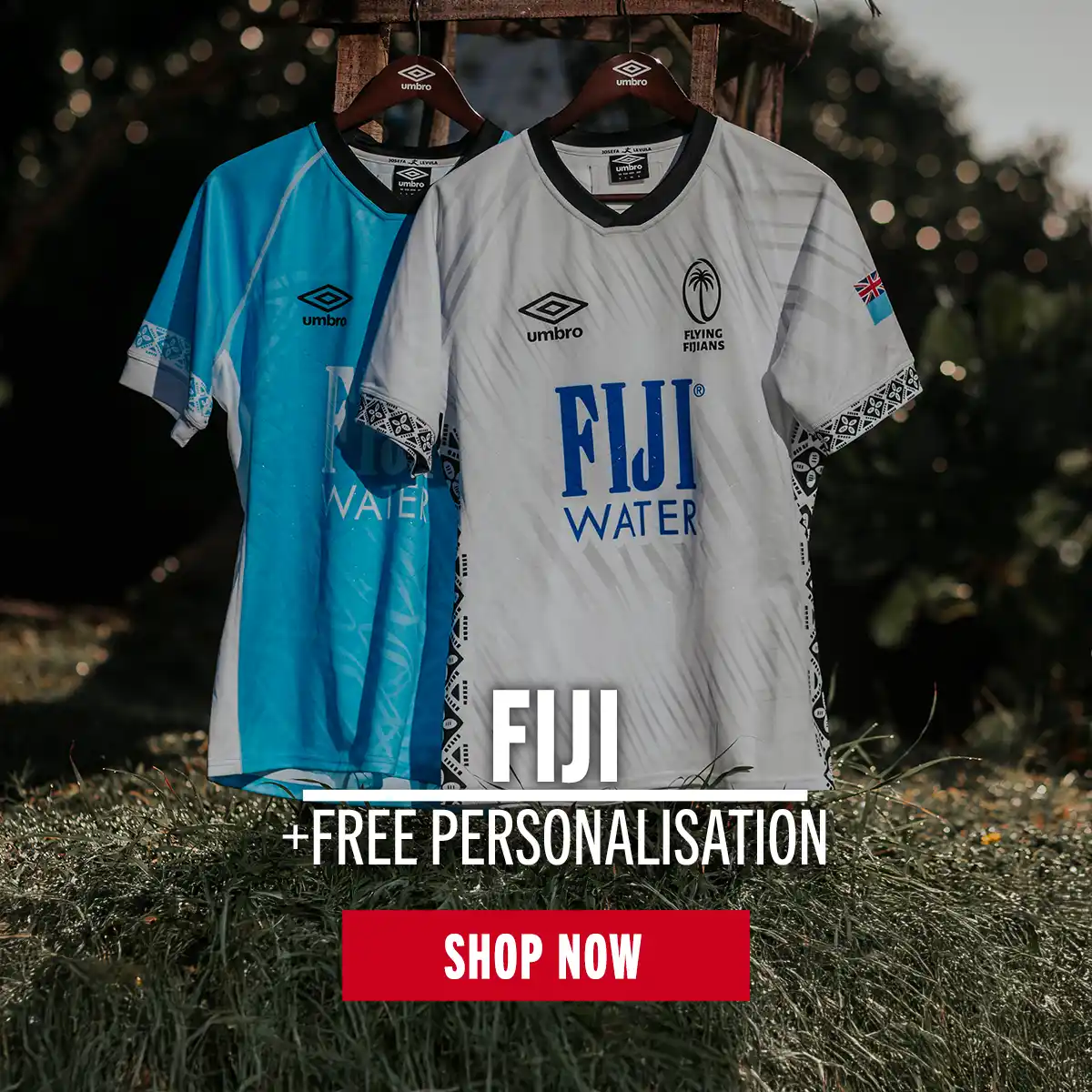 The Fiji home and away rugby shirts hang from a clothes hook on a tropical beach.