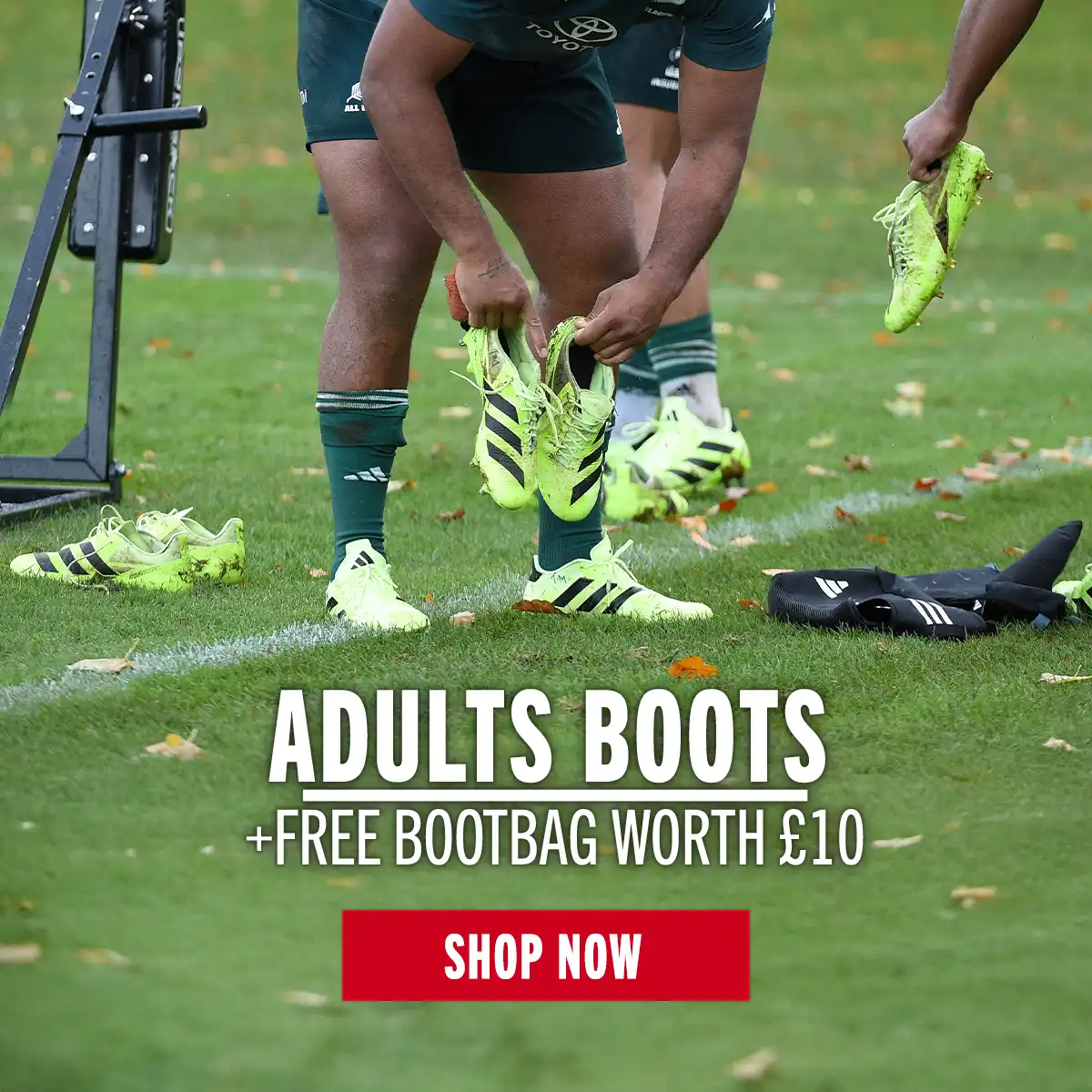 An All Blacks forward is picking up his boots at the end of training.