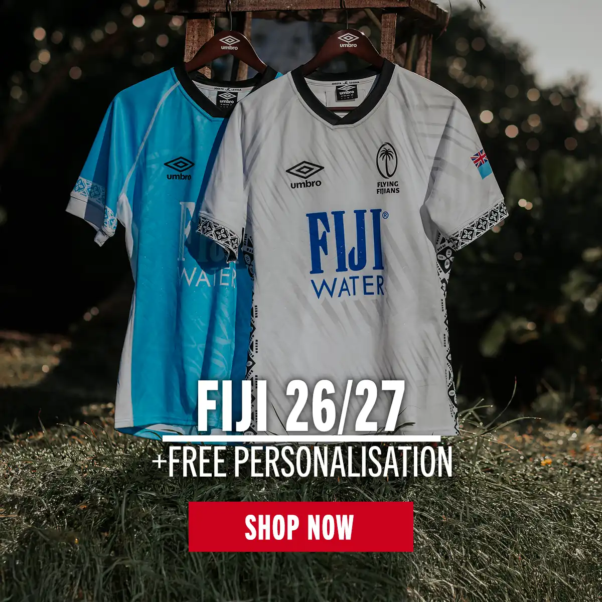 The Fiji home and away rugby shirts hang from a clothes hook on a tropical beach.