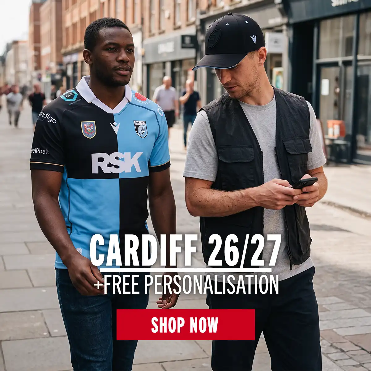 Two men are walking to the game in their new Cardiff kit.