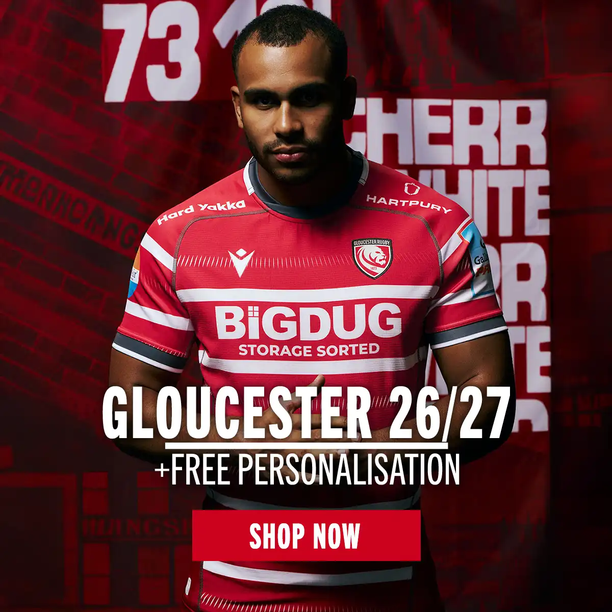 A Gloucester player stands in front of a red mural in the new 26/27 home kit.