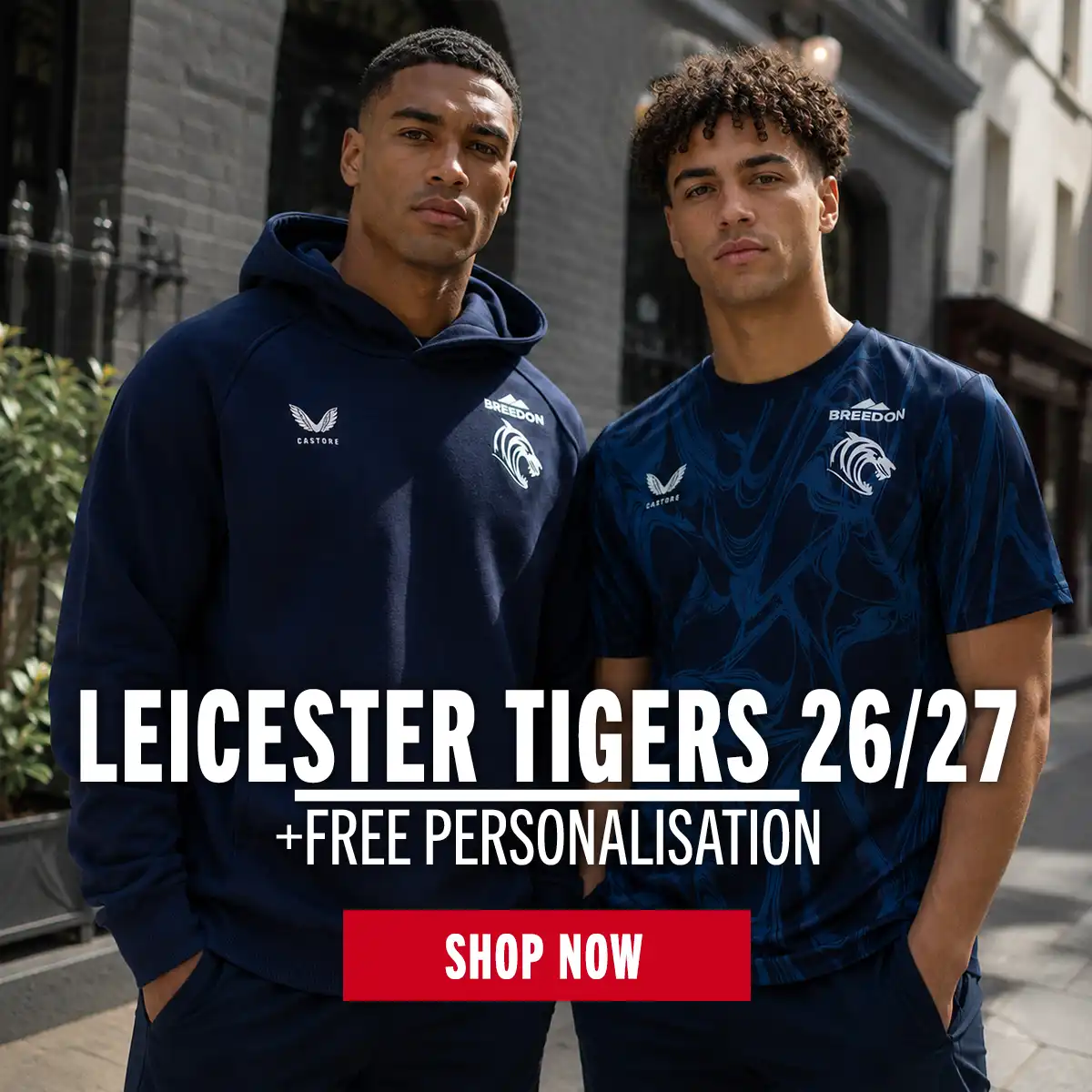 Two guys stand in the new travel clothes for Leicester Tigers.