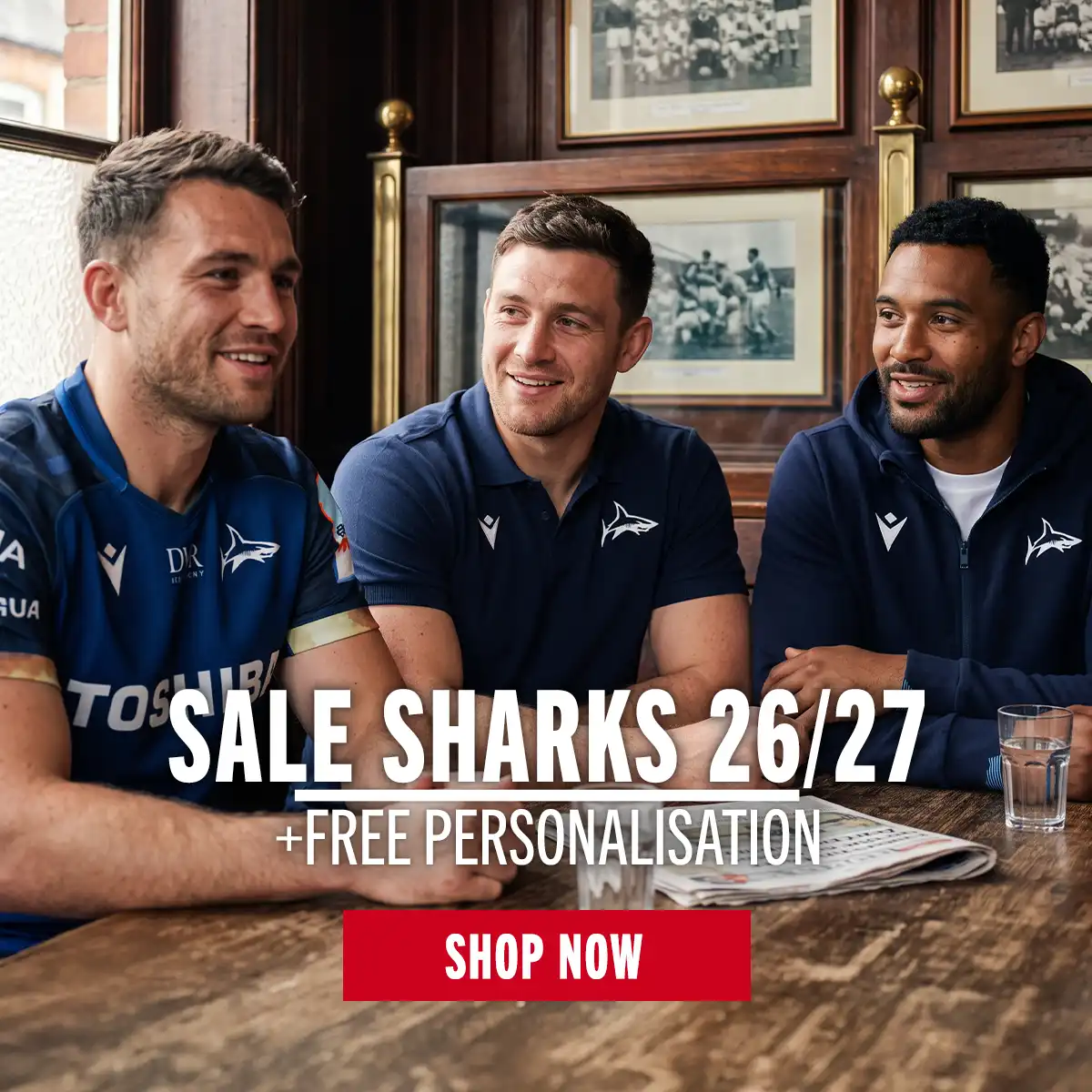 Three men sit in a pub wearing their new Sale Sharks kit.